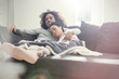 © Agnieszka Olek/Caia Image - Affectionate couple relaxing, watching TV on sofa