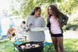 © Sam Edwards/Caia Image - Mother and daughter barbecuing at campsite