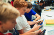 © Paul Bradbury/Caia Image - Junior high school boys using digital tablet in classroom
