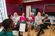 © Chris Ryan/Caia Image - Womens choir with sheet music singing in music recording studio