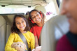 © Sam Edwards/Caia Image - Happy sisters riding in back seat of car