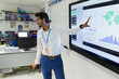 © Robert Daly/Caia Image - Male teacher leading lesson at screen in classroom