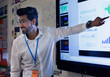 © Robert Daly/Caia Image - Smiling male teacher leading lesson at touch screen in classroom