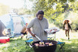 © Sam Edwards/Caia Image - Woman barbecuing at campsite