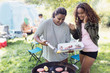 © Sam Edwards/Caia Image - Mother and daughter barbecuing at campsite