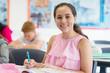 © Robert Daly/Caia Image - Portrait smiling, confident junior high school girl student doing homework in classroom
