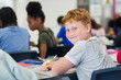 © Robert Daly/Caia Image - Portrait smiling, confident junior high school boy student studying at desk in classroom