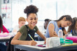 © Robert Daly/Caia Image - Portrait confident junior high school girl student doing homework in classroom