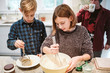 © Jarusha Brown/Caia Image - Brother and sister baking in kitchen
