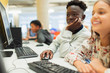 © Paul Bradbury/Caia Image - Junior high students using computer in computer lab