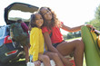 © Sam Edwards/Caia Image - Portrait happy sisters camping, unloading car