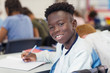 © Robert Daly/Caia Image - Portrait confident junior high school boy studying in classroom