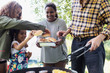 © Sam Edwards/Caia Image - Family barbecuing hamburgers