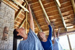 © Trevor Adeline/Caia Image - Women practicing yoga during retreat in hut