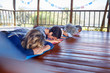 © Trevor Adeline/Caia Image - Serene people meditating in hut during yoga retreat
