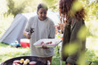 © Sam Edwards/Caia Image - Mother and daughter barbecuing at campsite
