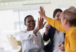 © Tom Merton/Caia Image - Businesswomen high-fiving in office