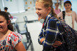 © Paul Bradbury/Caia Image - Happy, laughing junior high school girl student in classroom