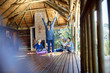 © Trevor Adeline/Caia Image - Woman leading yoga retreat in hut