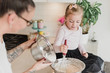 © Jarusha Brown/Caia Image - Mother and daughter baking