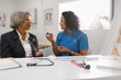 © Tom Merton/Caia Image - Female doctor teaching senior patient how to use glucometer in doctors office