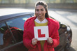 © Tom Merton/Caia Image - Portrait confident, happy young woman holding learners permit by car