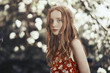 © Arman Zhenikeyev/Caia Image - Portrait serious girl in park