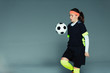 © Paul Bradbury/Caia Image - Teenage girl soccer player bouncing ball on knee