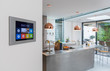 © Chris Ryan/Caia Image - Smart home navigation system on wall in kitchen