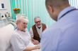 © Tom Merton/Caia Image - Doctor making rounds, talking with senior couple in hospital room