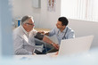 © Tom Merton/Caia Image - Male doctor checking blood pressure of senior patient in doctors office