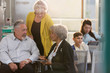 © Tom Merton/Caia Image - Female doctor with digital tablet talking with senior couple in clinic lobby