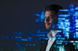 © Paul Bradbury/Caia Image - Double exposure businessman and city skyline at night