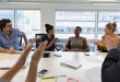 © Tom Merton/Caia Image - Happy business people clapping for colleague in conference room meeting