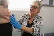 © Tom Merton/Caia Image - Female doctor examining pregnant woman in examination room