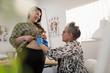 © Tom Merton/Caia Image - Female doctor examining pregnant woman in doctors office
