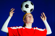 © Paul Bradbury/Caia Image - Teenage girl soccer player balancing soccer ball on head