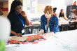 © Himalayan Pics/Caia Image - Female artists looking at screen print in art studio