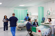 © Tom Merton/Caia Image - Doctors, nurses, patients and visitors in hospital ward