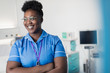 © Sam Edwards/Caia Image - Portrait confident, smiling female nurse in in hospital room