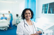 © Sam Edwards/Caia Image - Portrait smiling, confident female doctor using digital tablet in hospital room