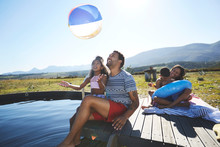 Playful Family With Beach Ball At Sunny, Summer Swimming Pool
