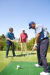 © Trevor Adeline/Caia Image - Male golfer practicing swing at golf driving range