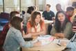 © Himalayan Pics/Caia Image - College students studying and talking at library table