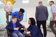 © Tom Merton/Caia Image - Doctor and nurse talking with boy patient in wheelchair in hospital ward