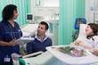 © Tom Merton/Caia Image - Doctor with medical chart making rounds, talking with couple in hospital room