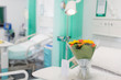 © Tom Merton/Caia Image - Flower bouquet and greeting card on tray in vacant hospital room