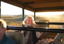 Happy Senior Woman On Safari Riding In Off-road Vehicle