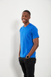 © Himalayan Pics/Caia Image - Portrait happy young man in blue t-shirt