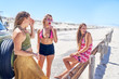 © Trevor Adeline/Caia Image - Young women friends relaxing at sunny summer beach